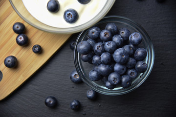 Blueberry yogurt in glass bowl on wooden table