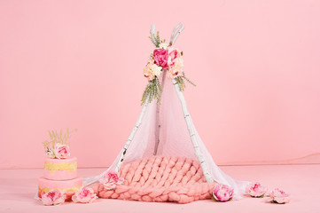 children's white awning with a cake on a pink background