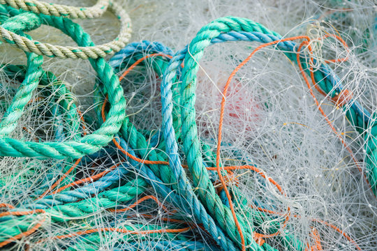 A tangled mess of fishing nets plastic rope and other debris washed up on a coastal beach ideal for an ecological hazard or pollution concept
