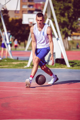 Obraz premium Handsome male playing basketball outdoor