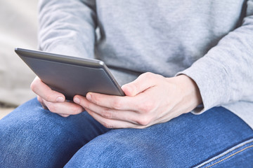 Man reading an e-book on digital tablet device