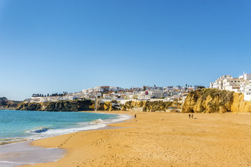 Fototapeta na wymiar Wide, sandy beach in white city of Albufeira, Algarve, Portugal