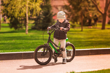Happy little boy riding a bike