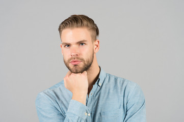 Guy with stylish hair touch beard with hand. Bearded man with healthy young skin. Macho with...