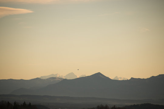 Chain of the mountain range of the alps in evening light with a ballon and a vignette filter