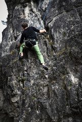 Obraz premium young man climber on limestone rock