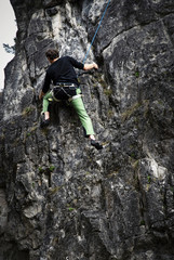 young man climber on limestone rock