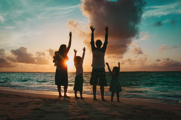 happy family with kids having fun at sunset
