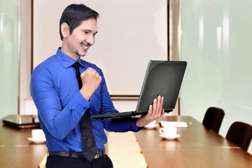 Successful asian businessman with laptop