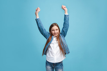 Happy success teen girl celebrating being a winner. Dynamic energetic image of female model