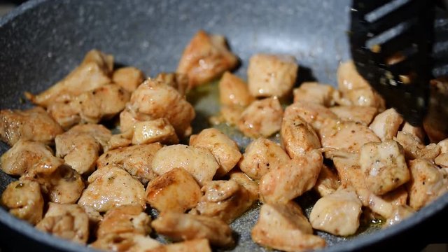 Pieces of chicken fillet fried in a pan