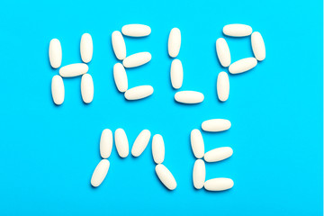 Pills are scattered over a blue background