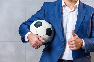 man in a suit with a soccer ball