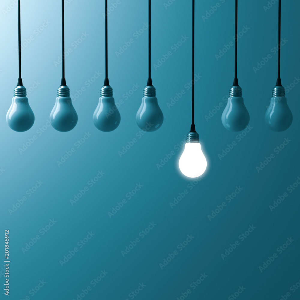 Poster one hanging light bulb glowing and standing out from unlit bulbs on dark blue green color background