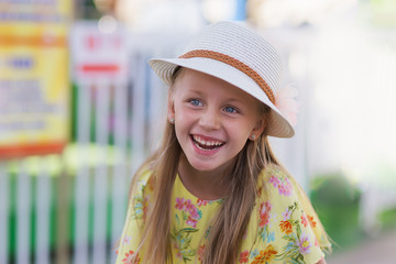 Cute little girl laughing outside