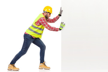 Male Construction Worker Is Pushing A White Wall