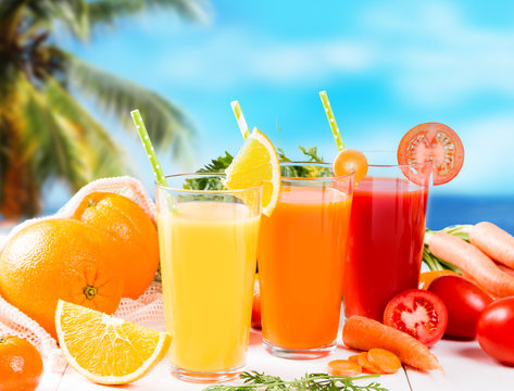 Fresh juice, Orange, apple, carrot and tomato drinks on white background. 