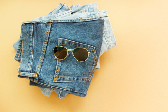 Picture of three jeans with glasses on craft wooden background