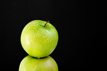 pyramid of two fresh juicy wet apples on black background