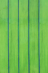 Green wooden planks background close up.