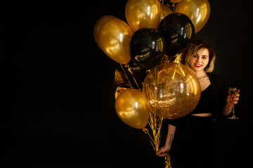 Happy Girl with Balloons and Champagne. Great Copy Space for Golden Text