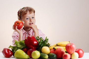 Fototapeta na wymiar Happy little girl and a lot of fruit and vegetables.