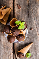 Ice cream, Chocolate scoop ice cream in cone on wooden table. 