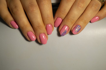 Manicure pink colored nails onsoft background