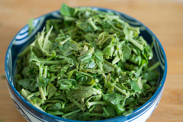 Preparing food, scald toona sinensis. Trees, food.