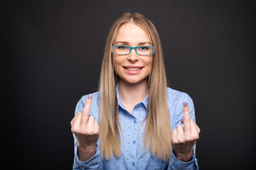 Business lady wearing blue glasses showing double obscene gesture.