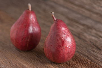 Red pear on wood table.