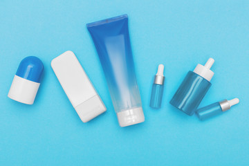 Flat lay composition with  cosmetics on blue background