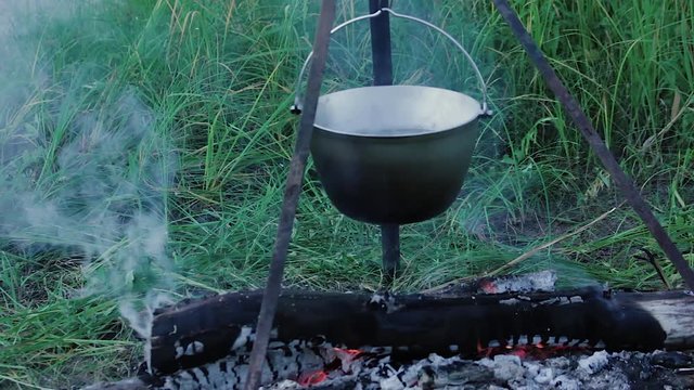 Bowler with an ear Bowler with soup boiling over the fire close 