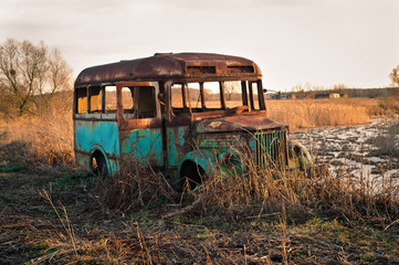 destroyed bus during sunset