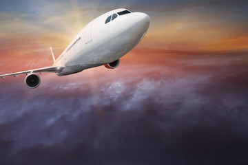 Fototapeta na wymiar Commercial airplane flying above clouds.