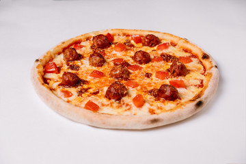 Pizza with meatballs and tomato isolated on white