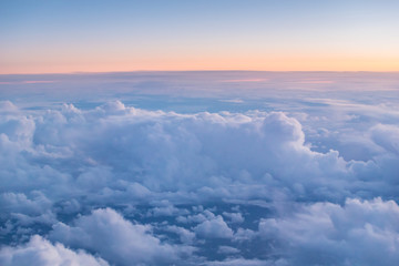 Obraz na płótnie Canvas Beautiful sunset with cloudy sky from the airplane window.
