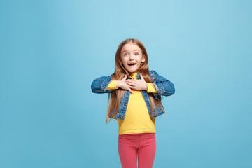 Beautiful teen girl looking suprised isolated on blue