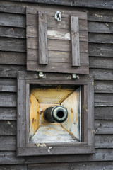 Pirate ship cannon window on old galleon.