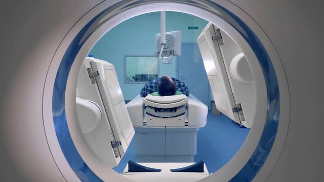 A man gets a scan in a hospital room.