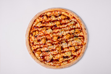 Pizza with chicken and pineapple isolated on white. Top view