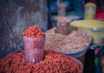 Various spices from the street market. Colorful georgian suneli on glasses in a row. Oriental spices and condiments