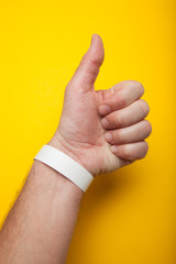 White wristband, bracelet mockup for event, wristlet with sticker.