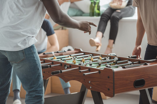 cropped image of man pointing by finger on table football board