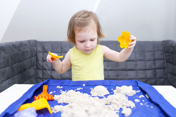 2 years girl plays kinetic sand at home