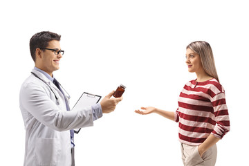 Doctor giving a bottle of pills to a young woman