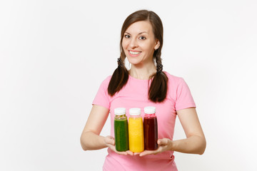 Fun woman holds row of green, red, yellow detox smoothies in bottles isolated on white background. Proper nutrition, vegetarian drink, healthy lifestyle, dieting concept. Copy space for advertisement.