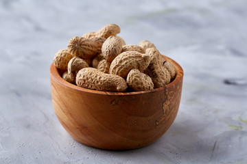 Composition of sea salt in ceramic bowl and spoon for cooking or spa on white background, top view, selective focus
