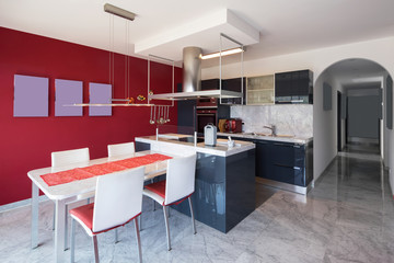 Modern kitchen with island, marble table and leather chairs