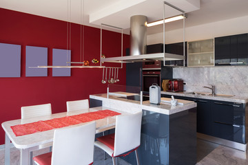 Modern kitchen with island, marble table and leather chairs
